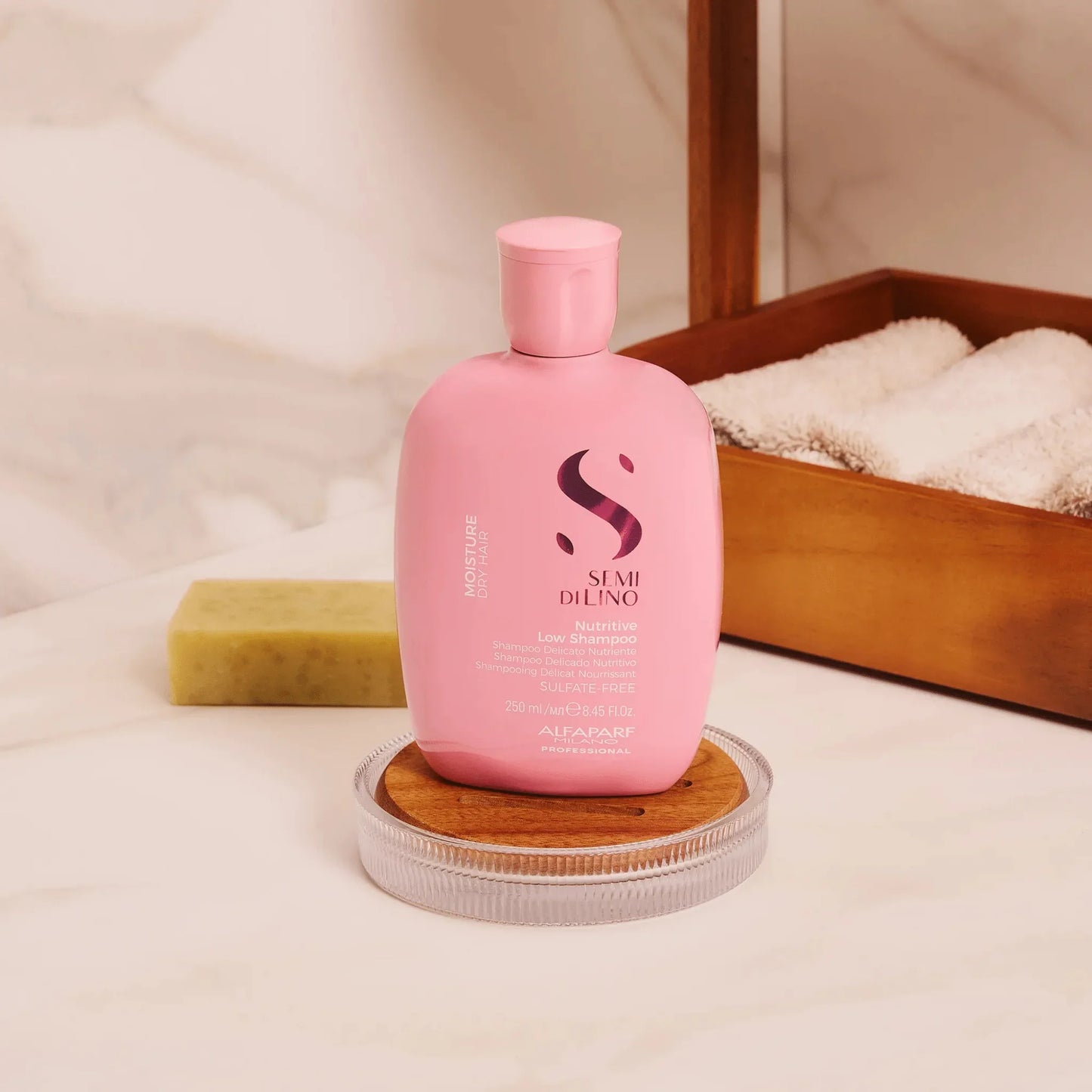 Pink Alfaparf Semi Di Lino Moisture Nutritive Shampoo bottle for dry hair on bathroom counter
