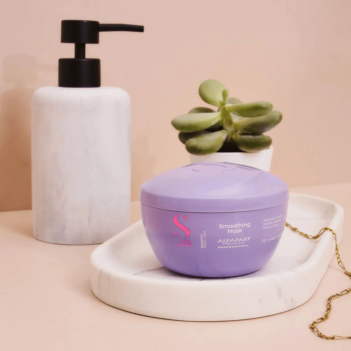Alfaparf Milano Smoothing Mask 200ml in a lavender jar on a bathroom tray with plant and soap dispenser